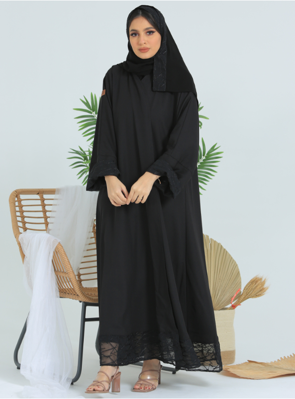 Cloche abaya A cloche abaya in a crepe fabric with the addition of a ...